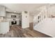 View of kitchen with stainless steel appliances, sink, hardwood floors, and staircase at 7324 Summerland Dr, Raleigh, NC 27612