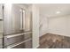 Kitchen with stainless steel refrigerator, hardwood floors, and stairs in the background at 7324 Summerland Dr, Raleigh, NC 27612