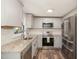 Kitchen featuring stainless steel appliances, granite countertops, and hardwood floors at 7324 Summerland Dr, Raleigh, NC 27612