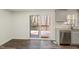 Open kitchen dining area with sliding glass door and stainless steel dishwasher at 7324 Summerland Dr, Raleigh, NC 27612