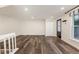 Living room with hardwood floors, closet and large window bringing in natural light at 7324 Summerland Dr, Raleigh, NC 27612