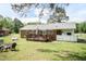 Charming brick home featuring a spacious backyard with a cozy deck, fire pit, and mature trees, perfect for outdoor enjoyment at 7698 Nc Highway 222, Kenly, NC 27542