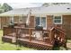 Outdoor deck features seating, flower boxes, string lights, and a charming space for entertaining at 7698 Nc Highway 222, Kenly, NC 27542