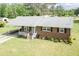 Inviting brick home with a covered front porch, lush lawn and mature trees at 7698 Nc Highway 222, Kenly, NC 27542