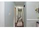 Well-lit hallway with wood flooring and neutral wall color at 7698 Nc Highway 222, Kenly, NC 27542