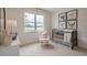 Bedroom with large windows and wallpaper features a rocking chair and baby crib at 770 Dorset Stream Dr, Fuquay Varina, NC 27526