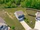 Aerial view of a charming home with a well-maintained lawn and tree-lined backyard at 80 Doonbeg Dr, Fuquay Varina, NC 27526