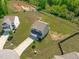 Aerial view of a beautiful home, with a spacious backyard and a serene pond nearby at 80 Doonbeg Dr, Fuquay Varina, NC 27526