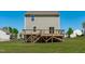 Backyard view with a wooden deck and stairs, perfect for outdoor enjoyment at 80 Doonbeg Dr, Fuquay Varina, NC 27526