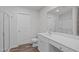 Well-lit bathroom features a shower, vanity, toilet, wood flooring and a large mirror at 80 Doonbeg Dr, Fuquay Varina, NC 27526