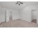 Carpeted bedroom with a ceiling fan, large window, and en-suite bathroom at 80 Doonbeg Dr, Fuquay Varina, NC 27526