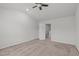 Carpeted bedroom includes neutral walls, ceiling fan, and door leading to hall at 80 Doonbeg Dr, Fuquay Varina, NC 27526
