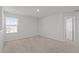 Carpeted bedroom with a large window and neutral walls for a bright, airy feel at 80 Doonbeg Dr, Fuquay Varina, NC 27526