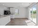 Bright dining area features wood-look floors and sliding glass doors to the backyard at 80 Doonbeg Dr, Fuquay Varina, NC 27526