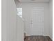 Bright entryway with white door, staircase, and wood-look flooring at 80 Doonbeg Dr, Fuquay Varina, NC 27526
