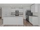 Bright kitchen features granite countertops, white cabinets, and stainless steel appliances at 80 Doonbeg Dr, Fuquay Varina, NC 27526
