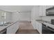 Open kitchen showcasing granite countertops, modern appliances, and seamless flow to the living area at 80 Doonbeg Dr, Fuquay Varina, NC 27526