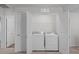 Conveniently designed laundry room with a washer, dryer and shelving for storage at 80 Doonbeg Dr, Fuquay Varina, NC 27526