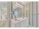 Bathroom featuring a double sink vanity, large mirror, and neutral decor at 8012 Glenbrittle Way, Raleigh, NC 27615