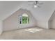 Bright bedroom with plush carpeting, a ceiling fan, and a charming arched window overlooking lush greenery at 8012 Glenbrittle Way, Raleigh, NC 27615