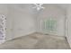 Inviting bedroom with neutral carpet, vaulted ceiling, a ceiling fan, and bright, shuttered windows at 8012 Glenbrittle Way, Raleigh, NC 27615