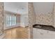 View of the dining room showcasing hardwood floors, floral wallpaper, and a convenient wet bar area at 8012 Glenbrittle Way, Raleigh, NC 27615