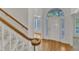 Bright foyer featuring hardwood floors, stairway, and a view into the adjacent living spaces at 8012 Glenbrittle Way, Raleigh, NC 27615