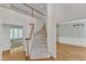 Bright foyer featuring hardwood floors, stairway, and a view into the adjacent living spaces at 8012 Glenbrittle Way, Raleigh, NC 27615