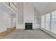Light-filled living room with a fireplace and built-in shelving, offering a cozy and inviting atmosphere at 8012 Glenbrittle Way, Raleigh, NC 27615