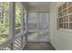 Cozy screened-in porch with brick flooring, offering a relaxing outdoor space at 8012 Glenbrittle Way, Raleigh, NC 27615
