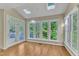 Bright sunroom featuring multiple windows, skylights, and access to the outdoor deck area at 8012 Glenbrittle Way, Raleigh, NC 27615