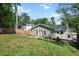 Lush backyard featuring a home's exterior, a pea gravel patio, and fenced yard at 806 Edmund St, Raleigh, NC 27604
