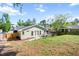 Charming backyard showcasing the home's exterior, a pea gravel patio, and fenced perimeter at 806 Edmund St, Raleigh, NC 27604