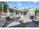 Beautiful backyard with a pea gravel patio, outdoor TV, fire pit, and lush greenery at 806 Edmund St, Raleigh, NC 27604