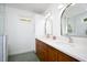 Bathroom featuring double vanities, custom cabinets, and modern lighting fixtures at 806 Edmund St, Raleigh, NC 27604