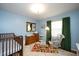 Cozy Bedroom with blue walls, crib, and rocking chair at 806 Edmund St, Raleigh, NC 27604