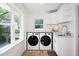 Bright laundry room featuring a modern washer, dryer, and ample natural light at 806 Edmund St, Raleigh, NC 27604