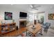 Bright living room boasts a ceiling fan, hardwood floors, fireplace, and ample natural light at 806 Edmund St, Raleigh, NC 27604