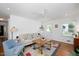 Bright living room boasts a ceiling fan, hardwood floors, fireplace, and ample natural light at 806 Edmund St, Raleigh, NC 27604