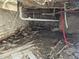 Unfinished basement showing exposed brick walls and plumbing, ideal for complete customization at 827 Sunset Ave, Rocky Mount, NC 27804