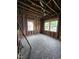 Unfinished bedroom space with exposed studs and new windows at 827 Sunset Ave, Rocky Mount, NC 27804