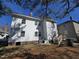 Rear exterior view of the house, featuring white siding and a yard with renovation needs at 827 Sunset Ave, Rocky Mount, NC 27804