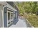 Enjoy relaxing outside on this wooden deck with blue siding and glass door access to the house at 8407 Millers Bnd, Bahama, NC 27503