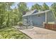 Exterior of the home highlights a stone fire pit, and a grassy lawn at 8407 Millers Bnd, Bahama, NC 27503