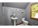 Elegant half bathroom features a pedestal sink and a window with tree views at 8407 Millers Bnd, Bahama, NC 27503
