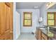 Bathroom with wood vanity, granite countertop, brushed nickel fixtures, a large window and a shower at 8407 Millers Bnd, Bahama, NC 27503
