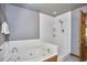 Relaxing bathtub with white subway tile surround and modern fixtures in a bright bathroom at 8407 Millers Bnd, Bahama, NC 27503