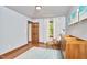 Bright bedroom featuring hardwood floors, a window, modern wood dresser and blue decorative rug at 8407 Millers Bnd, Bahama, NC 27503