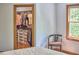 Open closet with custom organization and plentiful shelving, located near a bedroom window at 8407 Millers Bnd, Bahama, NC 27503