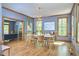 Bright dining room with modern chandelier, hardwood floors, and views of the surrounding greenery at 8407 Millers Bnd, Bahama, NC 27503